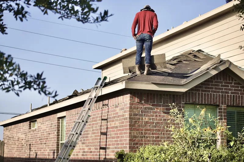 Professional roofer working on a residential roof in Darlington